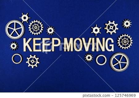 Keep Moving alphabet letters with gears element on navy blue background 125746969