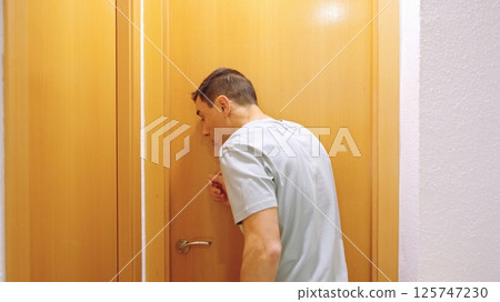 Impatient man waiting for occupied bathroom at home 125747230