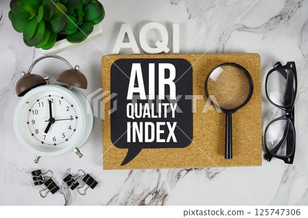 AQI - Air Quality Index acronym with alarm clock and magnifying glass, medical and healthcare concept background 125747306