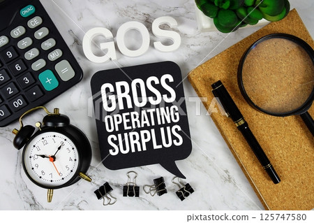 GOS - Gross Operating Surplus acronym with calculator, alarm clock and magnifying glass, Business and Financial concept background GOS - Gross Operating Surplus acronym with calculator, alarm clock and magnifying glass, Business and Financial concept background 125747580
