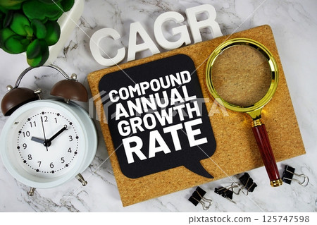 CAGR - Compound Annual Growth Rate acronym with alarm clock and magnifying glass, Business concept background 125747598