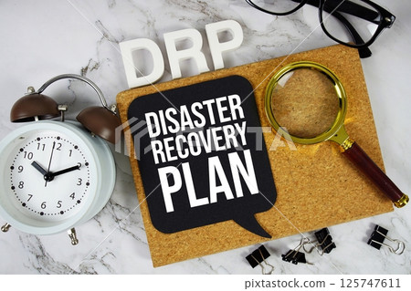 DRP - Disaster Recovery Plan acronym with alarm clock and magnifying glass, business concept background DRP - Disaster Recovery Plan acronym with alarm clock and magnifying glass, business concept background 125747611