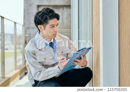 A young man in his 20s checking A young man in his 20s checking 125750293