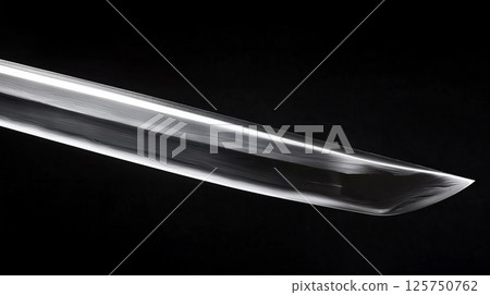 The tip of a Japanese sword on a black background. Metal texture, beautiful ripples The tip of a Japanese sword on a black background. Metal texture, beautiful ripples 125750762