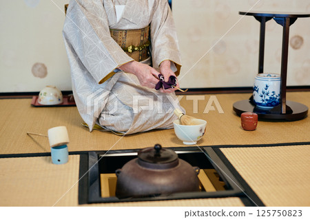 A woman demonstrating tea ceremony A woman demonstrating tea ceremony 125750823