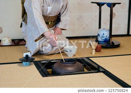 A woman demonstrating tea ceremony A woman demonstrating tea ceremony 125750824