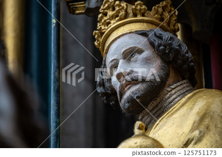 Nuremberg, Germany, August 2, 2023. Detail of one of the many statues that characterize the golden fountain in the market square. Travel destinations and tourist attractions. 125751173