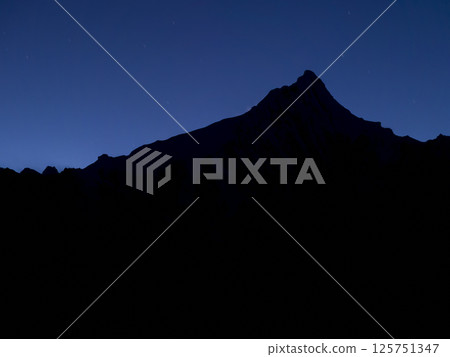 Steep mountain silhouette and evening sky / Kawa Karpo, Yunnan, China Steep mountain silhouette and evening sky / Kawa Karpo, Yunnan, China 125751347