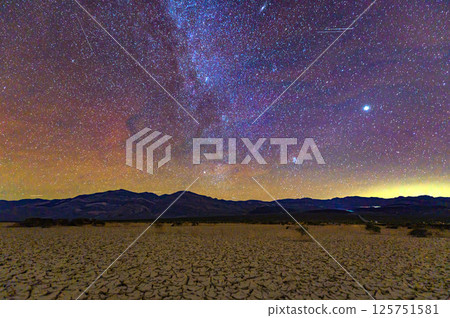 Milky Way Over Cracked Desert in Death Valley at Night 125751581