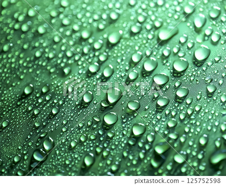 Image of water droplets and a water-repellent car hood (green) 125752598