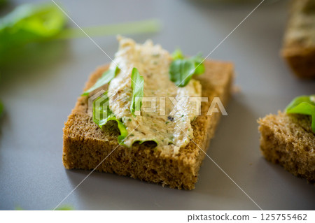 Homemade snack of rye bread with arugula and salad Homemade snack of rye bread with arugula and salad 125755462