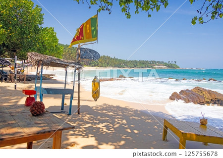 Tropical Silent Beach in Sri Lanka with turquoise sea, palm trees and white sand 125755678