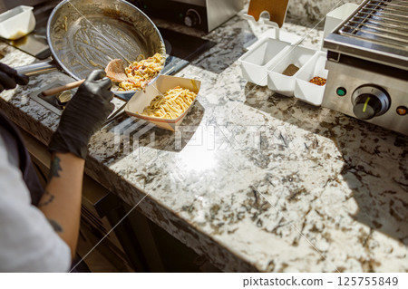 Talented Chef Skillfully Preparing a Delicious Meal on a Beautiful Granite Countertop Talented Chef Skillfully Preparing a Delicious Meal on a Beautiful Granite Countertop 125755849