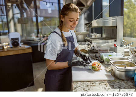 A Talented Chef Skillfully Preparing a Fresh and Delicious Dish in a Modern Kitchen Environment A Talented Chef Skillfully Preparing a Fresh and Delicious Dish in a Modern Kitchen Environment 125755877