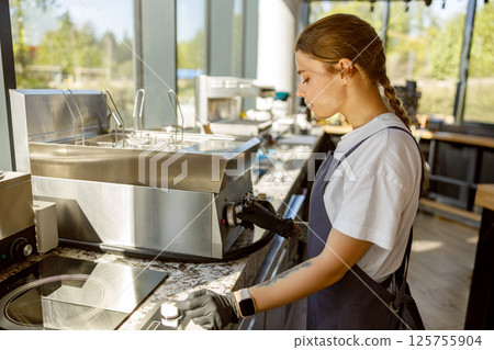 Barista Operating Espresso Machine in Modern Caf Barista Operating Espresso Machine in Modern Caf 125755904