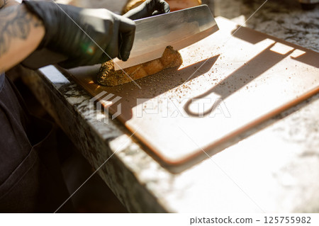 An Expert Chef Skillfully Slicing Fresh Ingredients with Precision and Care in the Kitchen An Expert Chef Skillfully Slicing Fresh Ingredients with Precision and Care in the Kitchen 125755982