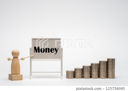 Stacks of money, a whiteboard and peg dolls Stacks of money, a whiteboard and peg dolls 125756095