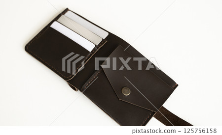 Open handmade leather wallet with card slots and coin pocket on white background Open handmade leather wallet with card slots and coin pocket on white background 125756158