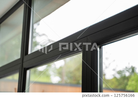 High-efficiency window corner with glossy insulated spacer strip and textured frame 125756166