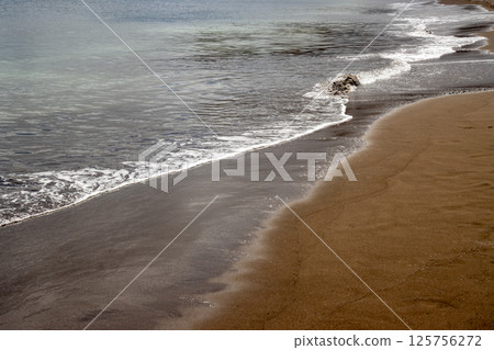 Sand beach and a line of the tide, Gran Canaria, Spain 125756272