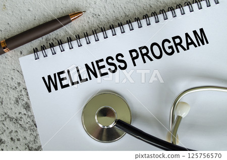 Top view of Wellness Program text on white paper notepad with stethoscope on wooden table background. Health and medical concept. Top view of Wellness Program text on white paper notepad with stethoscope on wooden table background. Health and medical concept. 125756570