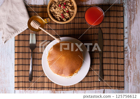 Pancake breakfast with honey and granola Pancake breakfast with honey and granola 125756612