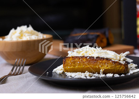 Baked plantains with white cheese 125756642