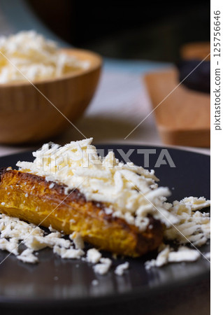 Baked plantains with white cheese 125756646