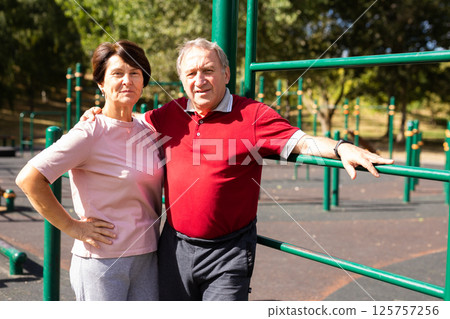 Elderly man and woman posing in open-air sports bars complex 125757256