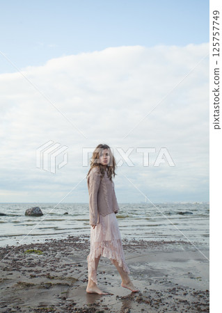 Barefoot spring woman walking outdoors on nature background, fashion beauty portrait 125757749