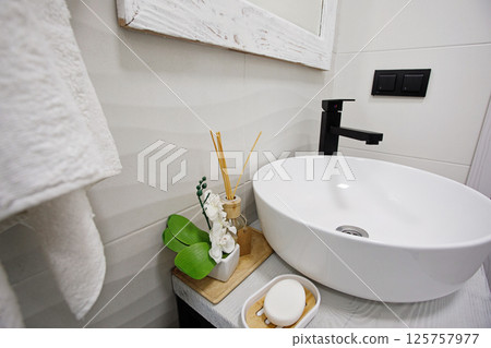 Round bathroom washing sink on wooden surface, interior detail 125757977