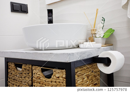 Modern and clean toilet, sink and toiletries 125757978
