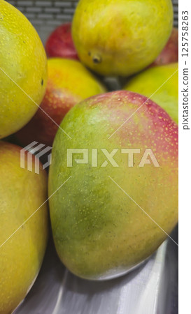Mango fruits on the counter in the supermarket. Prepared for sale. Healthy food 125758263