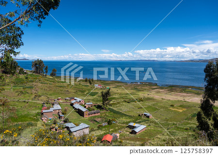 Scenic view of Lake Titicaca from Llachon with rural houses 125758397