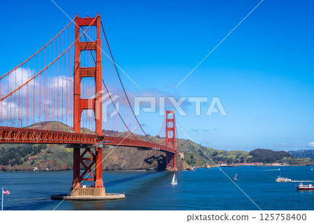 Golden Gate Bridge over blue waters with scenic hills in San Francisco 125758400