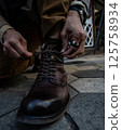 Man's legs standing at the door 125758934