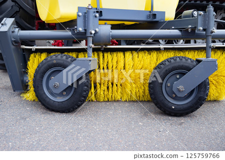 Close-up of industrial street sweeper brush and wheels. 125759766