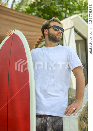 Surfer Riding Waves on His Bright Red Board While Enjoying Vibrant Coastal Vibes Surfer Riding Waves on His Bright Red Board While Enjoying Vibrant Coastal Vibes 125759828