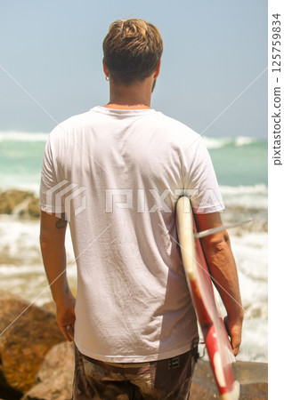 A Surfer Getting Excited and Prepared to Catch a Perfect Wave at the Beautiful Beach on a Sunny Day A Surfer Getting Excited and Prepared to Catch a Perfect Wave at the Beautiful Beach on a Sunny Day 125759834