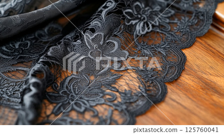 Black lace fabric with floral pattern texture used for fashion and design 125760041