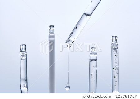 Five different droppers with facial serum in a row. Five different droppers with facial serum in a row. 125761717