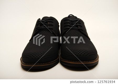 Blue leather summer men's boots on a white background. Half-boots with ventilation holes. Light shoes. 125761934