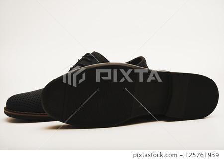 Blue leather summer men's boots on a white background. Half-boots with ventilation holes. Light shoes. Blue leather summer men's boots on a white background. Half-boots with ventilation holes. Light shoes. 125761939