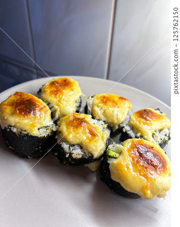 Homemade sushi rolls served on plate. Non chef cooked. Regular homemade food. Authentic look. Homemade sushi rolls served on plate. Non chef cooked. Regular homemade food. Authentic look. 125762150