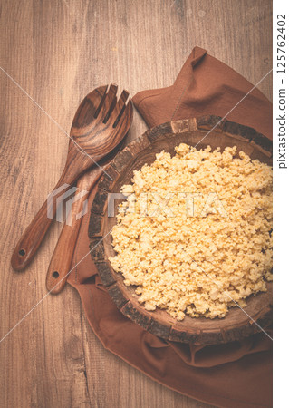 cooked couscous, in a wooden bowl, top view, no people, 125762402