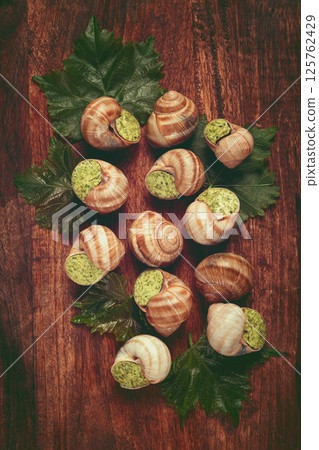 snails stuffed in Burgundy, top view, with grape leaves, French cuisine, no people, snails stuffed in Burgundy, top view, with grape leaves, French cuisine, no people, 125762429