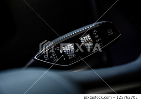 Close up view of car light switch control. Headlight switch, turn signal lever Close up view of car light switch control. Headlight switch, turn signal lever 125762705