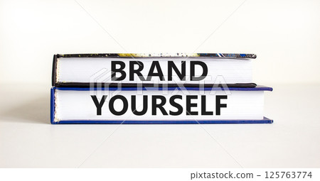 Brand yourself symbol. Concept words Brand yourself on beautiful books. Beautiful white table white background. Business brand yourself concept. Copy space. Brand yourself symbol. Concept words Brand yourself on beautiful books. Beautiful white table white background. Business brand yourself concept. Copy space. 125763774