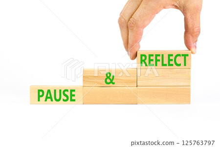 Pause and reflect symbol. Concept words Pause and reflect on beautiful block. Businessman's hand. Beautiful white background. Business motivational lifestyle pause and reflect concept. Copy space. 125763797