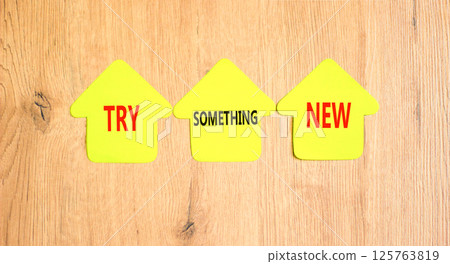 Try something new symbol. Concept words Try something new on beautiful yellow paper houses. Beautiful wooden background. Business motivational lifestyle try something new concept. Copy space. Try something new symbol. Concept words Try something new on beautiful yellow paper houses. Beautiful wooden background. Business motivational lifestyle try something new concept. Copy space. 125763819